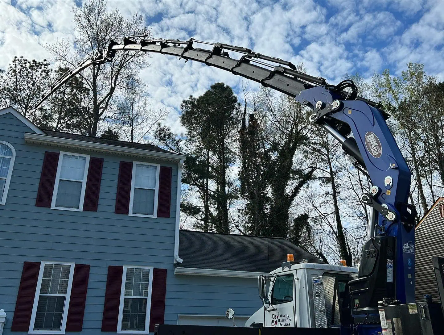 Crane-assisted tree removal in Cobb County GA near house